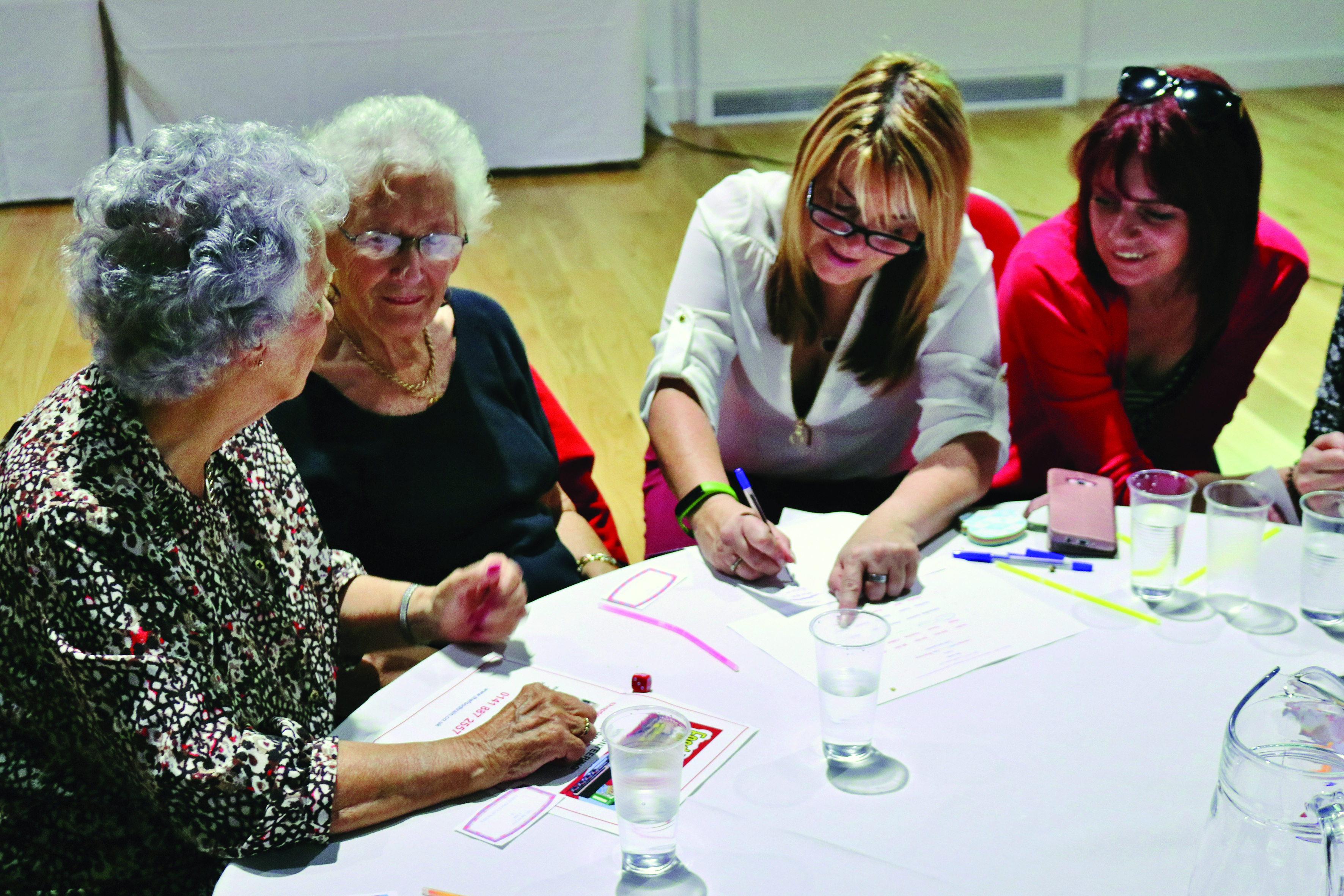 Group of women around table at women's Centre networking day in Johnstone