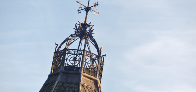 Top of a building which has a weather vane