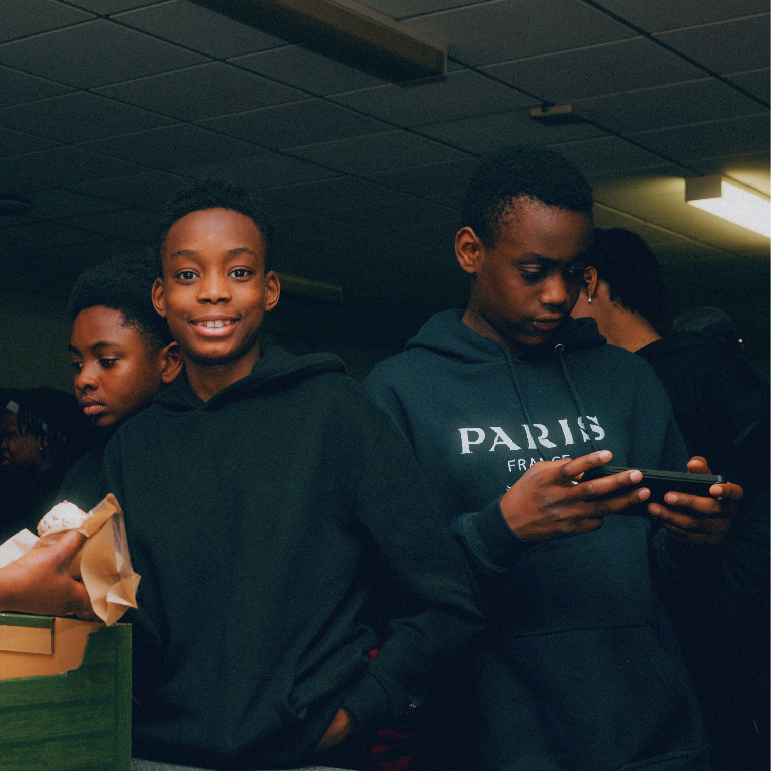 Close up of three children at a community centre