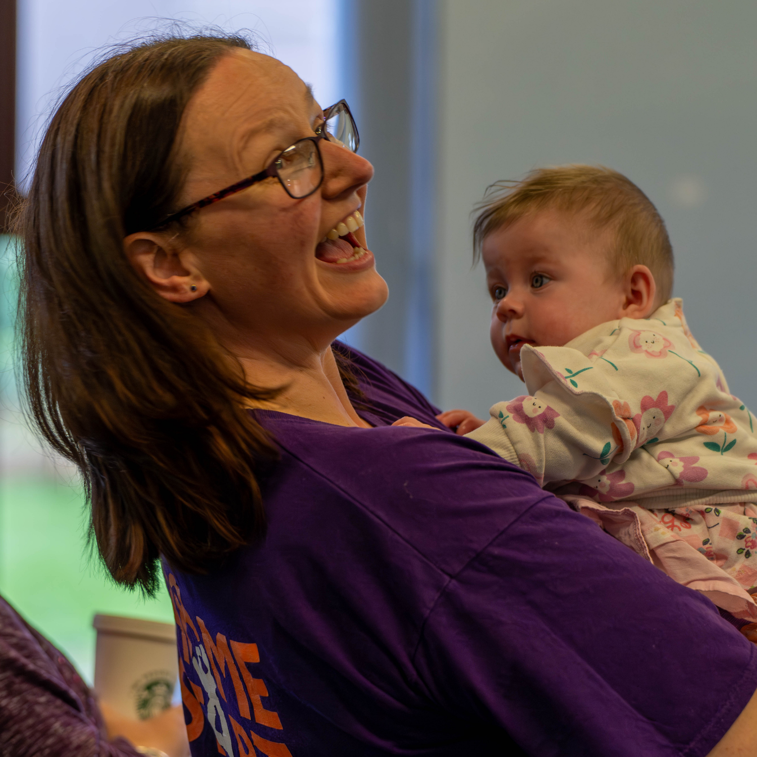 Home-Start staff member holding a baby
